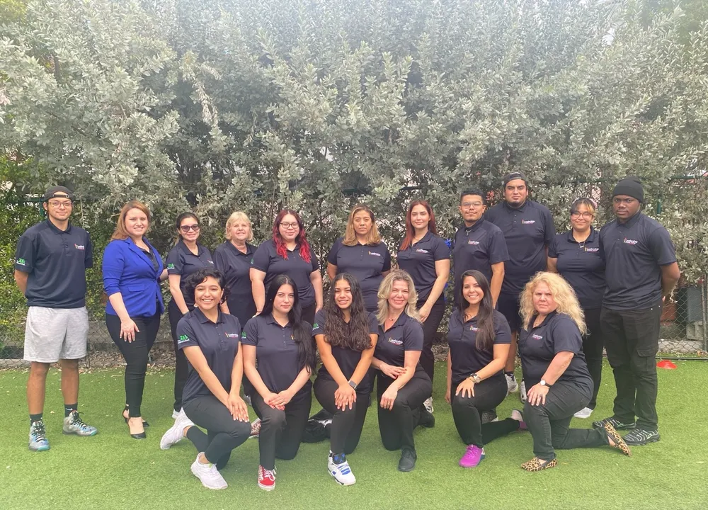 The Leadership Learning Center staff team gathered outdoors on the grass.